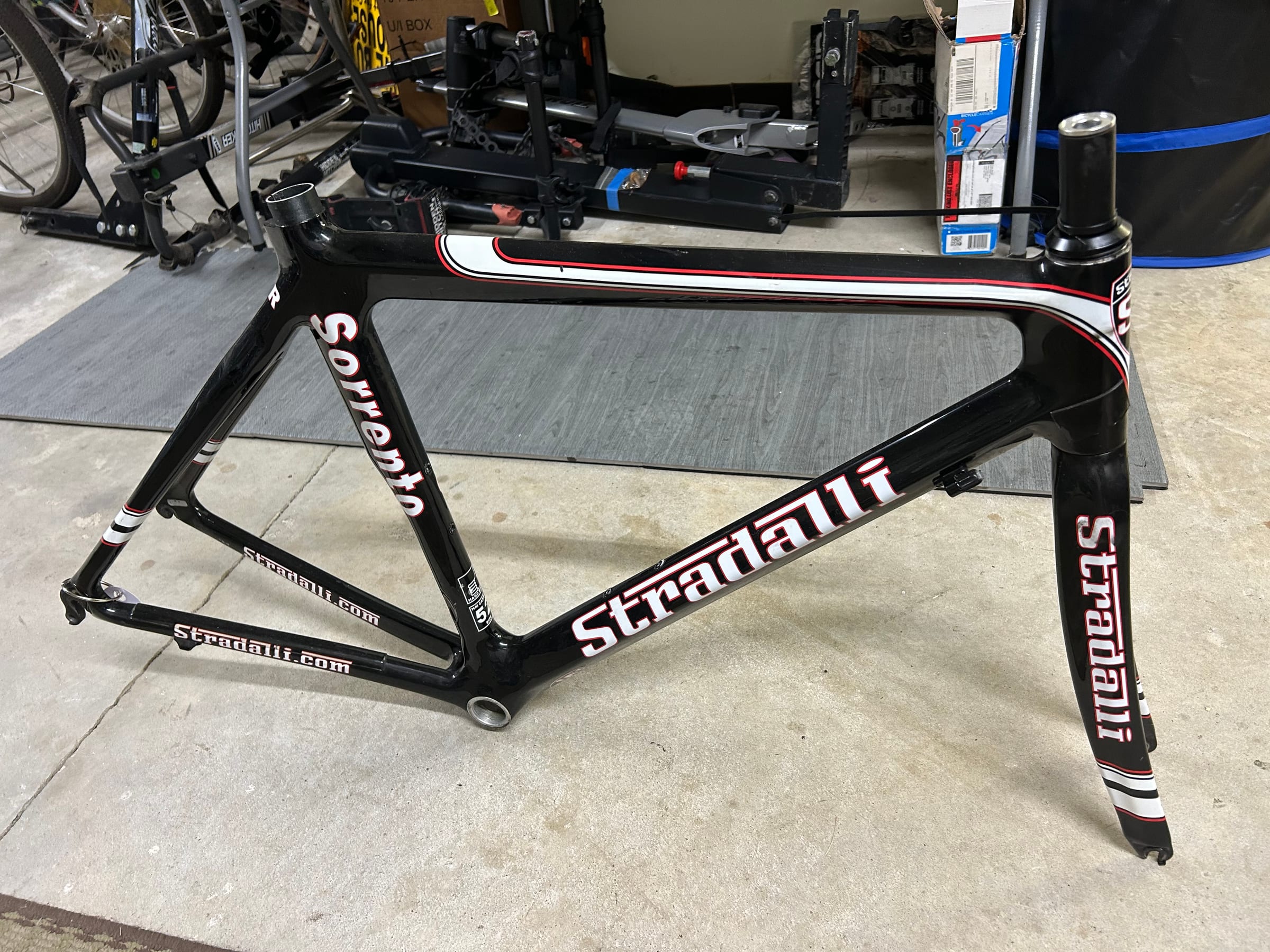 The donated 2012 Stradalli Sorrento carbon frame and fork, standing on its own in black, white, and red.