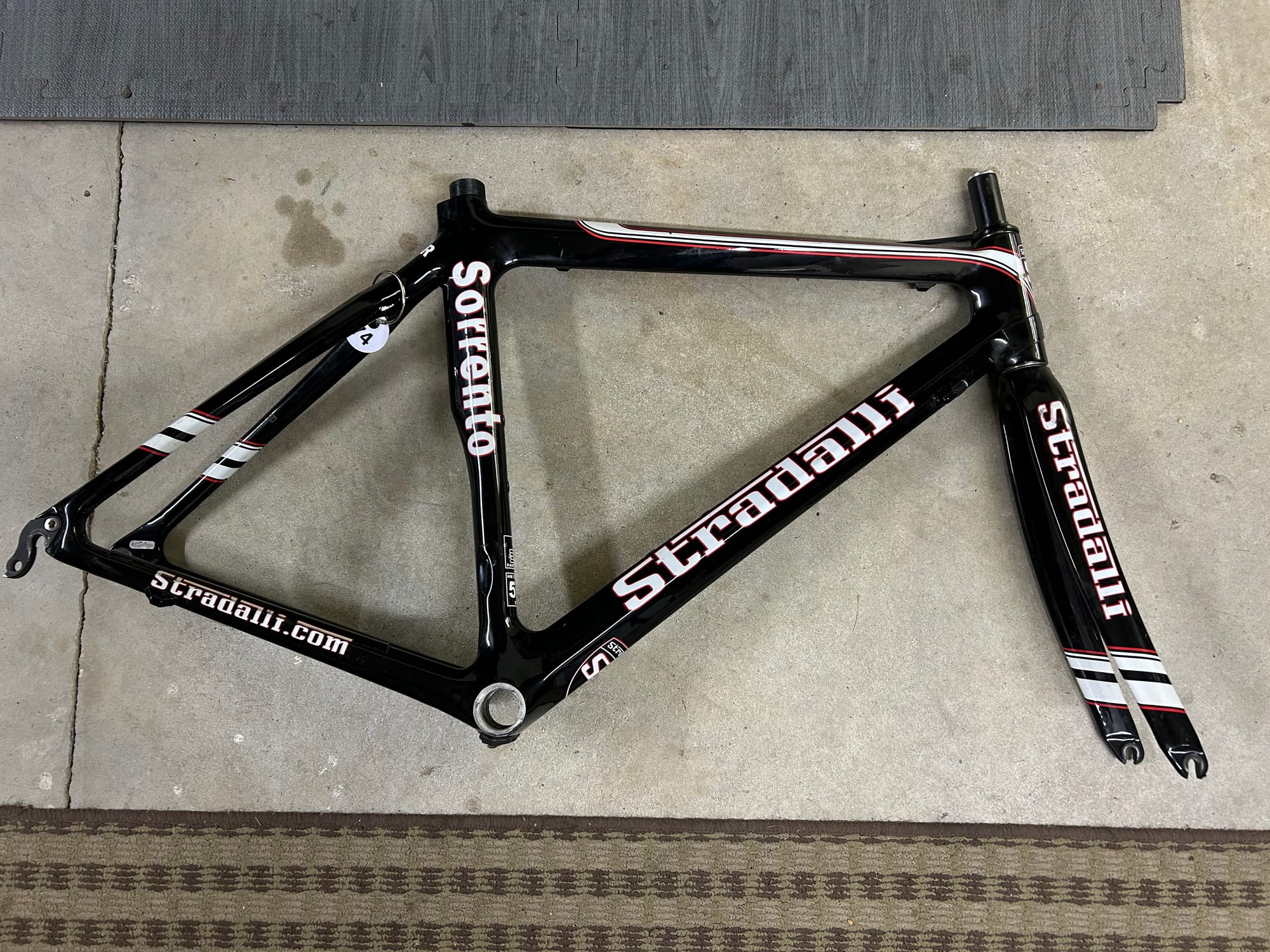 The bare Stradalli frame and fork laid out on the floor, showing the full silhouette from above.